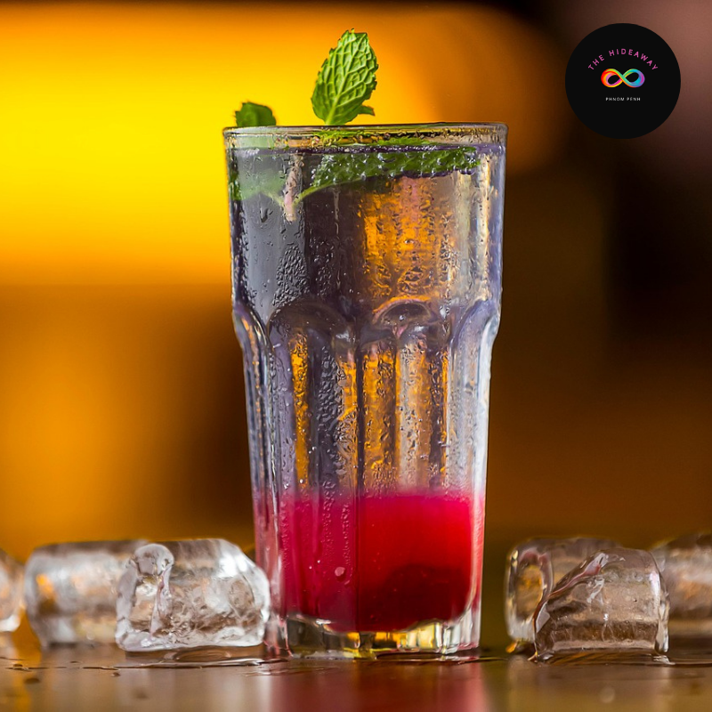 Elegant The Pink Triangle in a cocktail glass, part of a Pride-themed menu in Cambodia