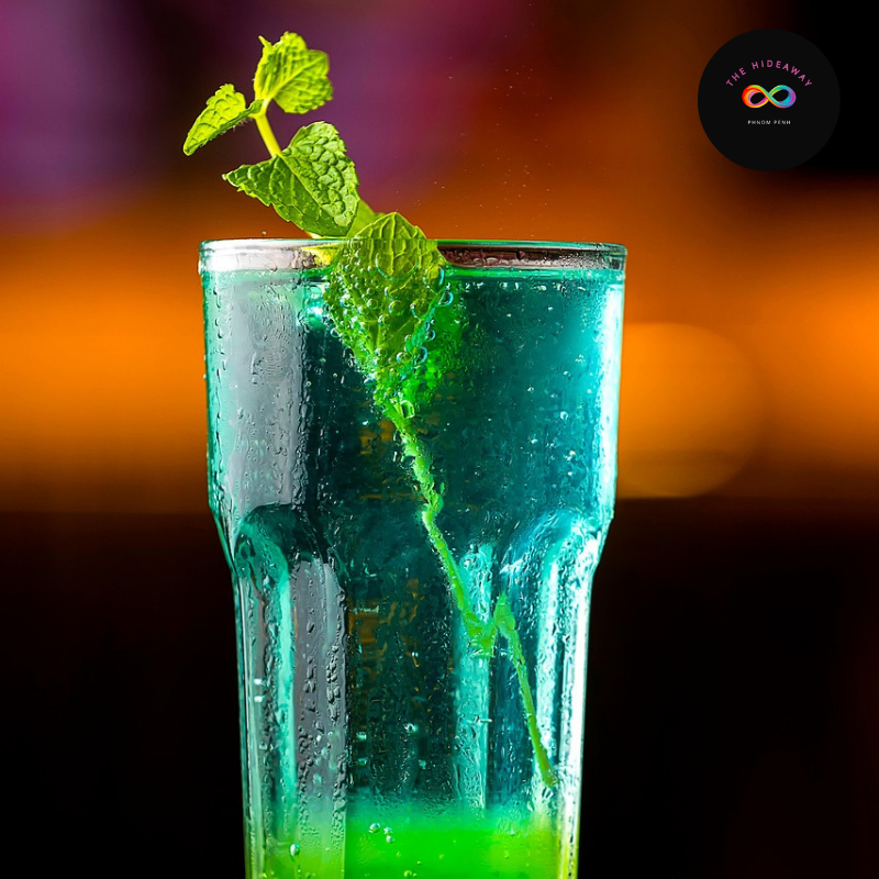 Premium Violet Hour cocktail with garnish, representing Phnom Penh's vibrant LGBTQ+ nightlife