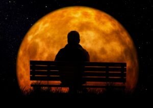 park bench in front of red moon in retirement